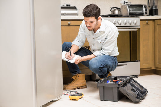 Technician handling junk removal in a home kitchen, illustrating residential junk removal services in Pensacola.